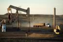 A service truck drives past an oil well on the Fort Berthold Indian Reservation in North Dakota