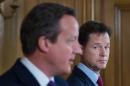 Britain's Prime Minister David Cameron (L) and Deputy Prime Minister Nick Clegg address a press conference at 10 Downing Street in London on July 10, 2014