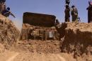 An image from jihadist Twitter account Al-Baraka news on June 11, 2014 allegedly shows ISIL militants as a bulldozer cuts a road through the Syrian-Iraqi border