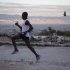 In this Jan. 7, 2013 photo, Astrel Clovis, a 42-year-old marathon runner, trains in the early morning in Petionville, a suburb of Port-au-Prince, Haiti.  Like virtually all Haitians in the capital of 3 million, the runner's life was disrupted by the catastrophic earthquake on Jan. 12, 2010. But a month later he was back on the streets, resuming his routine along with the rest of the country. Six days a week, the rail-thin athlete sets off at daybreak. Clovis has run the hills and streets of Port-au-Prince for the past 10 years. He decided to take the sport seriously after he entered a race in downtown Port-au-Prince on a whim - and won. (AP Photo/Dieu Nalio Chery)