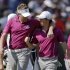 Europe's Ian Poulter and Rory McIlroy talk as they walk up the first hole during a four-ball match at the Ryder Cup PGA golf tournament Saturday, Sept. 29, 2012, at the Medinah Country Club in Medinah, Ill. (AP Photo/Chris Carlson)