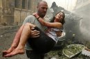 A wounded woman is carried at the site of an explosion in Ashrafieh