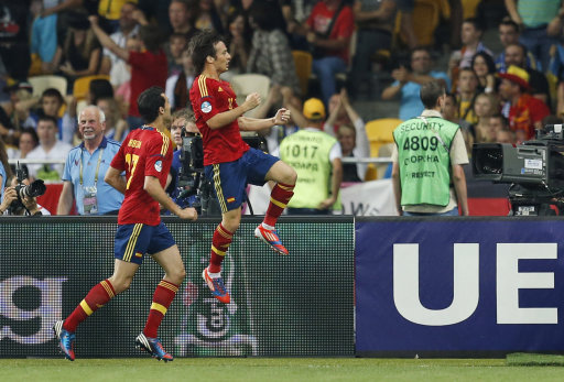 Spain's David Silva jumps to celebrate after he scored the first goal in front of teammate Alvaro Arbeloa during the Euro 2012 soccer championship final between Spain and Italy in Kiev, Ukraine, Sunday, July 1, 2012. (AP Photo/Matthias Schrader)
