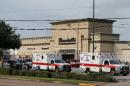 Ambulance crews on standby after a gunman went on a shooting rampage wounding nine before he was shot and killed by police on September 26, 2016 in Houston, Texas