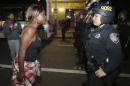 Amanda Ashe of Oakland faces off with a police officer during a demonstration in Oakland, California