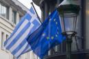 A Greek and a European flag flutter outside the Greek embassy in Brussels