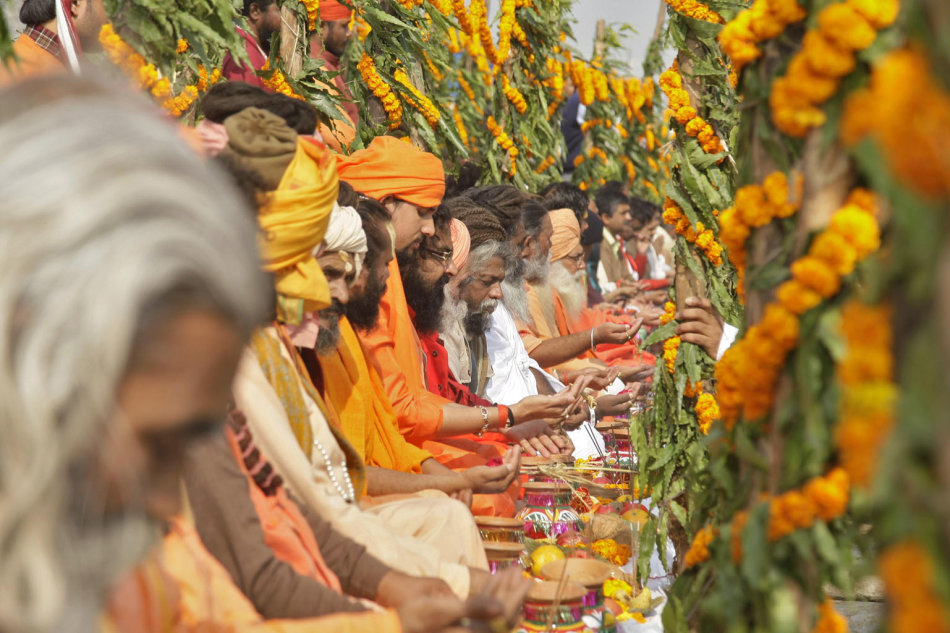 Hindu holy men, also known as "Sadhus", perform prayers for a peaceful "Kumbh Mela", or Pitcher Festival, on the banks of the river Ganges in Allahabad