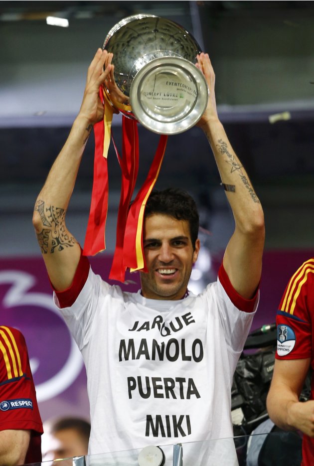 Spain's Fabregas lifts up the trophy after defeating Italy to win the Euro 2012 final soccer match at the Olympic stadium in Kiev