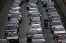FILE - In this March 18, 2016, file photo, cars slow on heavy traffic in Mexico City. City officials have issued their sixth pollution alert of the year Tuesday, May 24, 2016, and ordered more cars off the road to reduce emissions. (AP Photo/Marco Ugarte, File)