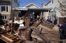 Members of the United States Coast Guard help clear a house in Midland Beach neighborhood in Staten Island