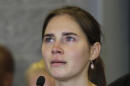 FILE - In this Tuesday, Oct. 4, 2011 file photo, Amanda Knox talks to reporters, in Seattle. A court in Florence that convicted Amanda Knox in her British roommate's 2007 murder says the wounds indicate multiple aggressors, and that the two exchange students fought over money the night of the murder. The appellate court on Tuesday, April 29, 2014, issued a 337-page explanation for its January guilty verdicts against Knox and her former boyfriend Raffaele Sollecito. Knox, 26, was sentenced to 28 ½ years while Sollecito, 30, received 25 years. Knox has been in the United States since 2011, when an earlier appellate trial that overturned her lower court conviction. Sollecito remains in Italy. The release of the court's reasoning opens the verdict to an appeal back to the supreme Court of Cassation. If the high court confirms the convictions, a long extradition fight for Knox is expected. Kercher, 21, was found dead in a pool of blood in the apartment she and Knox shared in the town of Perugia. (AP Photo/Ted S. Warren, File)