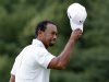 Tiger Woods acknowledges the gallery after putting on the 18th hole during the third round of the U.S. Open golf tournament at Merion Golf Club, Saturday, June 15, 2013, in Ardmore, Pa. (AP Photo/Gene J. Puskar)