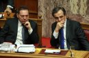 Greece's Prime Minister Antonis Samaras, right, and Finance Minister Yannis Stournaras attend a vote for the new austerity measures at the Greek parliament in Athens, Wednesday, Nov. 7, 2012. Greek lawmakers have narrowly passed a crucial austerity bill by majority vote, but with heavy dissent from within the three-party governing coalition. (AP Photo/Thanassis Stavrakis)