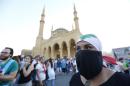 A Lebanese protester wears a mask and a national flag on her head during a mass rally on August 29, 2015 at the iconic Martyrs Square in Beirut