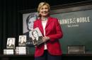 Hillary Clinton poses with her new book "Hard Choices" during a book signing in New York