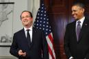 US President Barack Obama (R) laughs as his French counterpart Francois Hollande makes a statement to the media followoing their tour of Monticello on February 10, 2014 in Charlottesville, Virginia