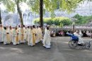 Catholics take part in a procession during a mass to celebrate the Feast of the Assumption