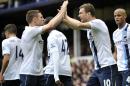 Manchester City's Edin Dzeko, right, celebrates with teammate James Milner after scoring the second goal of the game during their English Premier League soccer match against Everton at Goodison Park in Liverpool, England, Saturday May 3, 2014. (AP Photo/Clint Hughes)