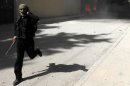 An Al Nusra fighter runs as the group's base is shelled in Raqqa province on March 14.