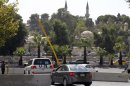 U.N. vehicles transport members of an U.N. chemical weapons investigation team in Damascus