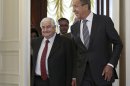Russian Foreign Minister Sergey Lavrov welcomes his Syrian counterpart Walid al-Moallem, left, prior to talks in Moscow on Monday, Sept. 9, 2013. (AP Photo/Ivan Sekretarev)
