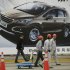 Workers walk past a poster of a car ahead of the Shanghai International Automobile Industry Exhibition (AUTO Shanghai) at the Shanghai International Exhibition Center in Shanghai, China Thursday, April 18, 2013. These should be good times for Chinese automakers as they prepare to show off their latest models at the Shanghai auto show. Their home market is the world's biggest and growing. But independent automakers such as Chery and Geely are being squeezed by bigger, richer global rivals including General Motors and Nissan that are creating low-priced models for local tastes. Domestic brands account for less than half of their own market.  (AP Photo/Eugene Hoshiko)
