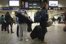 Travelers walk through Penn Station in New York
