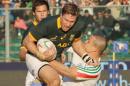 South Africa's Jean De Villiers, left, is grabbed by Italy's Luca Morisi, during an international rugby union test match between Italy and South Africa, in Padua, Italy, Saturday, Nov. 22, 2014. (AP Photo/Paolo Giovannini)