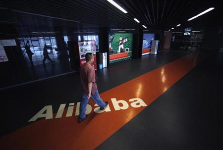 An employee walks past a logo of Alibaba (China) Technology Co. Ltd during a media tour organised by government officials at its headquarters on the outskirts of Hangzhou, Zhejiang province June 20, 2012. REUTERS/Carlos Barria