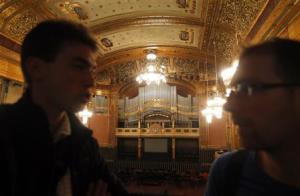 Two men talk above the reopened large concert hall …