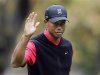 Tiger Woods waves after making a birdie on the 16th hole during the final round of the World Challenge golf tournament in Thousand Oaks, California
