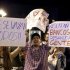 Demonstrators against Spain's bailout hold up signs in Madrid
