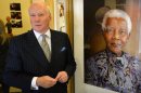 British artist Richard Stone poses with a print of his portrait of Nelson Mandela painted in 2008 and diplayed at the "We love Mandela" exhibition at the South Africa House in central London on October 2, 2013