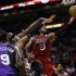 Sacramento Kings' Patrick Patterson (9) watches as DeMarcus Cousins (15) tries to block Miami Heat's Dwyane Wade (3) during the first half of an NBA basketball game in Miami, Tuesday, Feb. 26, 2013. (AP Photo/J Pat Carter)