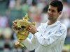 Djokovic holds the trophy after beating Rafael Nadal in last year's Wimbledon men's singles final