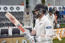 Kane Williamson (L) of New Zealand walks out onto the field at the start of the days play during day four of the second cricket Test match between New Zealand and Australia at the Hagley Park Oval in Christchurch on February 23, 2016