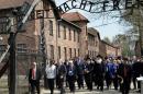 Participants pass the main gate of the former Nazi German Auschwitz-Birkenau death camp during the 'March of the Living' at in Oswiecim, Poland on April 16, 2015