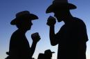 Country music fans drink beer as night falls during final day of Stagecoach country music festival in Indio