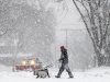 Steve Gordon of Madison, Wis., walks his dogs along Grandview Blvd. on the city's south side as a steady snowfall moves throughout the area Thursday, Dec. 20, 2012. The first major snowstorm of the season began its slow eastward march across the Midwest Thursday, creating treacherous, sometimes deadly driving conditions and threatening to disrupt some of the nation's busiest airports ahead of the holiday weekend. (AP Photo/Wisconsin State Journal, John Hart)