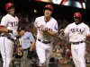 Texas Rangers  David Murphy, center, and teammates Leonys Martin, left, and Elvis Andrus, right,  are all smiles after Murphy hit a three-run home run during the sixth inning of a baseball game Sunday, May 19, 2013, in Arlington.  (AP Photo/John F. Rhodes)
