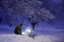 A local resident clears snow from his driveway after an overnight snowfall left many schools and businesses closed for the day, Thursday, Dec. 20, 2012, in Urbandale, Iowa. (AP Photo/Charlie Neibergall)