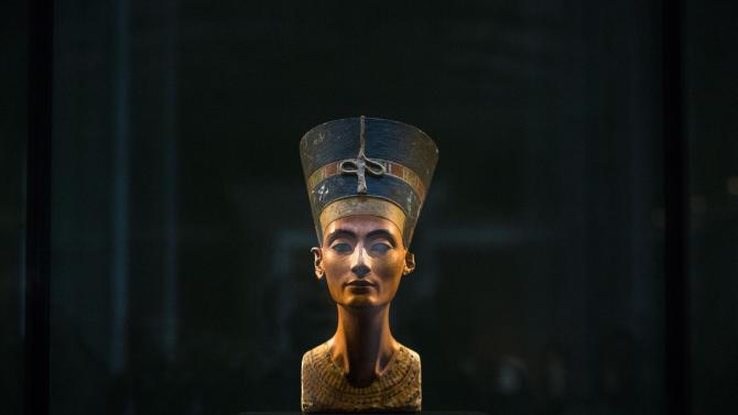 FILE - In this Sept. 10, 2014 file photo, a 3,300-year-old bust of Queen Nefertiti stands on its socle, at the New Museum in Berlin, Germany. An Egyptian official says the Antiquities Ministry gave an initial approval for the use of non-invasive radar to verify a theory that Queen Nefertiti’s crypt may be hidden behind King Tutankhamun’s 3,300-year-old tomb in the famous Valley of the Kings.  (AP Photo/Markus Schreiber, File)