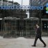 FILE - In this Aug. 7, 2012 file photo, a man walks past the headquarters of Standard Chartered bank in London. Benjamin Lawsky, New York's superintendent of financial services, said Tuesday, Aug. 14, 2012, that his agency has reached a $340 million settlement with Standard Chartered Bank to resolve an investigation into whether the British bank schemed with the Iranian government to launder $250 billion from 2001 to 2007. (AP Photo/Sang Tan, File)