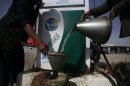 A man fills a canister with petrol that he says was brought from Iran, at a roadside petrol station on the outskirts of Quetta