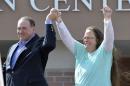 FILE - In this Tuesday, Sept. 8, 2015, file photo, Rowan County Clerk Kim Davis, with Republican presidential candidate Mike Huckabee at her side, greets the crowd after being released from the Carter County Detention Center, in Grayson, Ky. Having failed to ban same-sex marriage, many religious conservatives are now working to carve out protections for business owners and others who object to it on religious grounds. To some of them, Davis is a hero for her willingness to go to jail rather than issue marriage licenses. But others think Davis' position as a government official makes her exactly the wrong figure to rally around. (AP Photo/Timothy D. Easley, File)