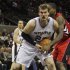 Spurs' Splitter gets tied up by Raptors' Davis during the second half of their NBA basketball game in San Antonio