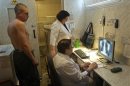 A man is x-rayed to detect tuberculosis during a medical examination, organized by the Belarusian Red Cross society, in Minsk