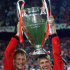 FILE - In this May 26, 1999, file photo, Manchester United's Teddy Sheringham, left, and David Beckham celebrate with the trophy after defeating Bayern Munich 2-1 to win the UEFA Champions League soccer final in Barcelona. Sheringham's goal in the 91st minute and Ole Gunnar Solksjaer's in the 93rd caused Manchester United's comeback to be considered one of the all-time greatest in sports history. (AP Photo/Camay Sungu, File)