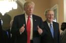 U.S. President-elect Donald Trump gives a thumbs up sign as he walks with Senate Majority Leader McConnell on Capitol Hill in Washington
