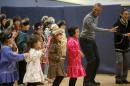 Obama performs a traditional Yup'ik dance at a school in Dillingham, Alaska